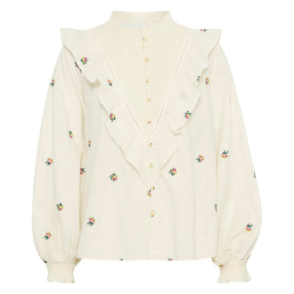 Cream-colored floral-embroidered Birch Olivia Blouse by Atelier Rêve with ruffle details and long sleeves.