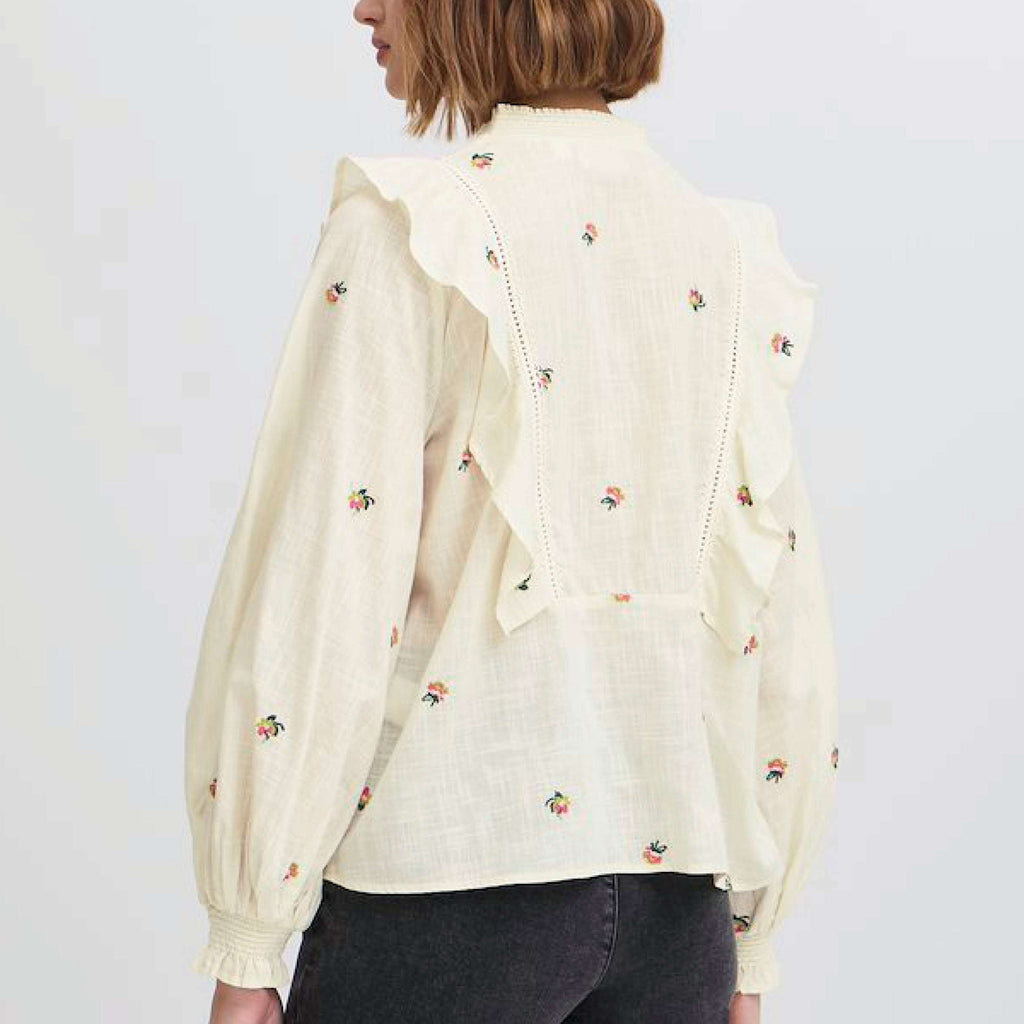 Cream Atelier Reve Birch Olivia Blouse with floral embroidery and ruffle details.