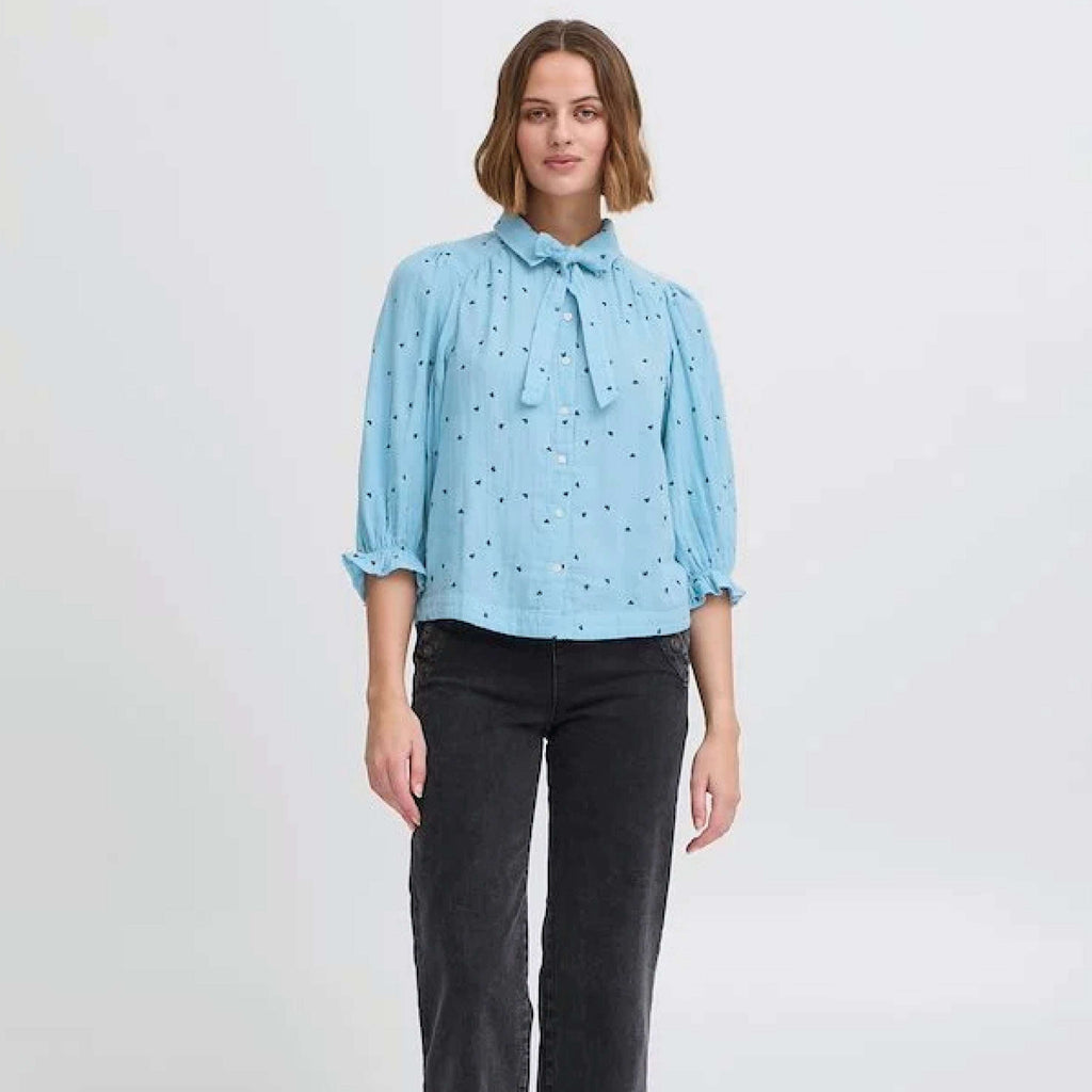 Atelier Reve Dusk Blue Camilo Blouse with heart embroidery and tie neck.