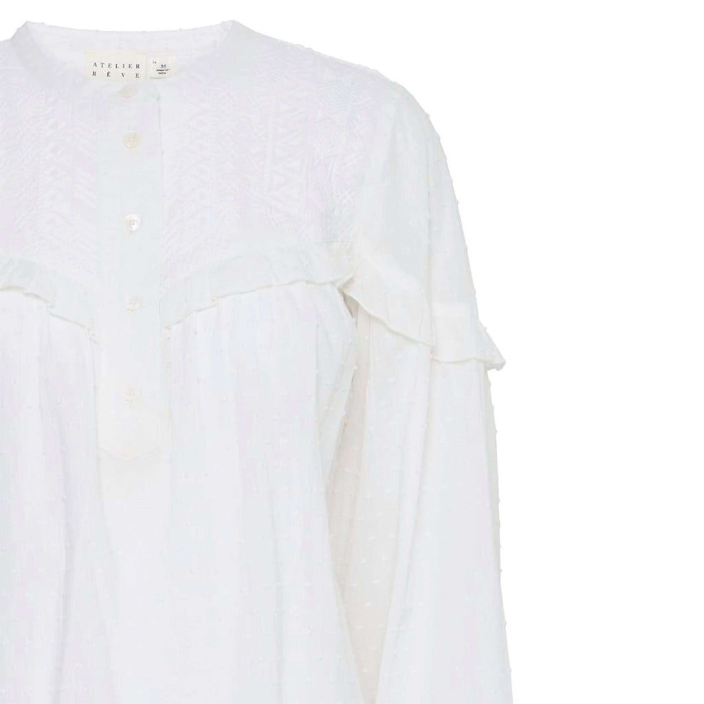 Atelier Reve Snow White Lauren Blouse with frill detail, button neck, and textured cotton fabric.