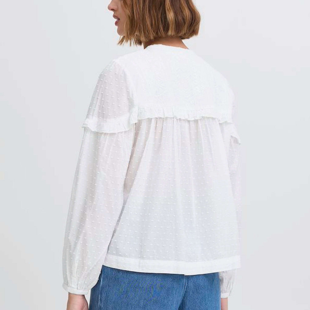 Atelier Reve Snow White Lauren Blouse with frill details, button neck, and textured cotton fabric.