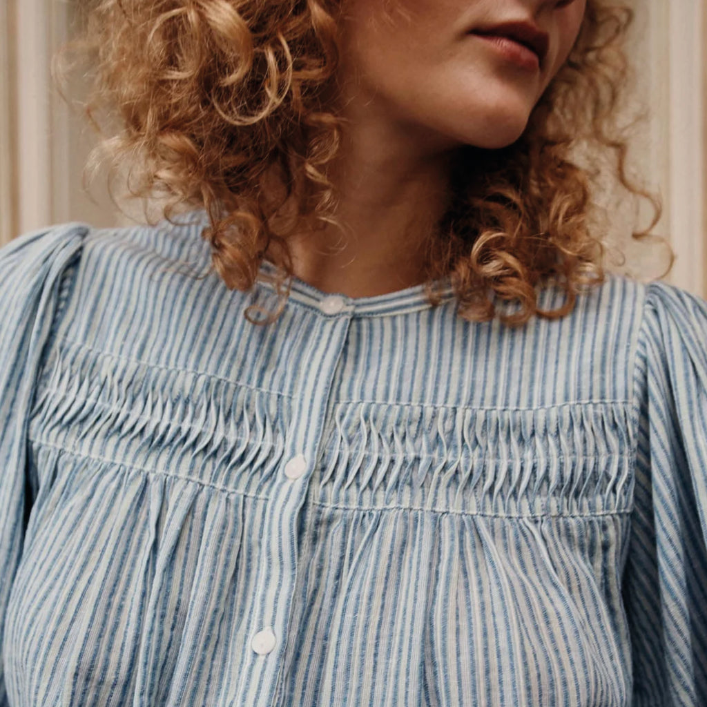 A blue and white blouse with pin stripe, buttoned centre, round neckline and lace inserts.
Louise Misha Blue Parasol Striped Jally Blouse - Jo And Co Louise Misha Blue Parasol Striped Jally Blouse - Louise Misha