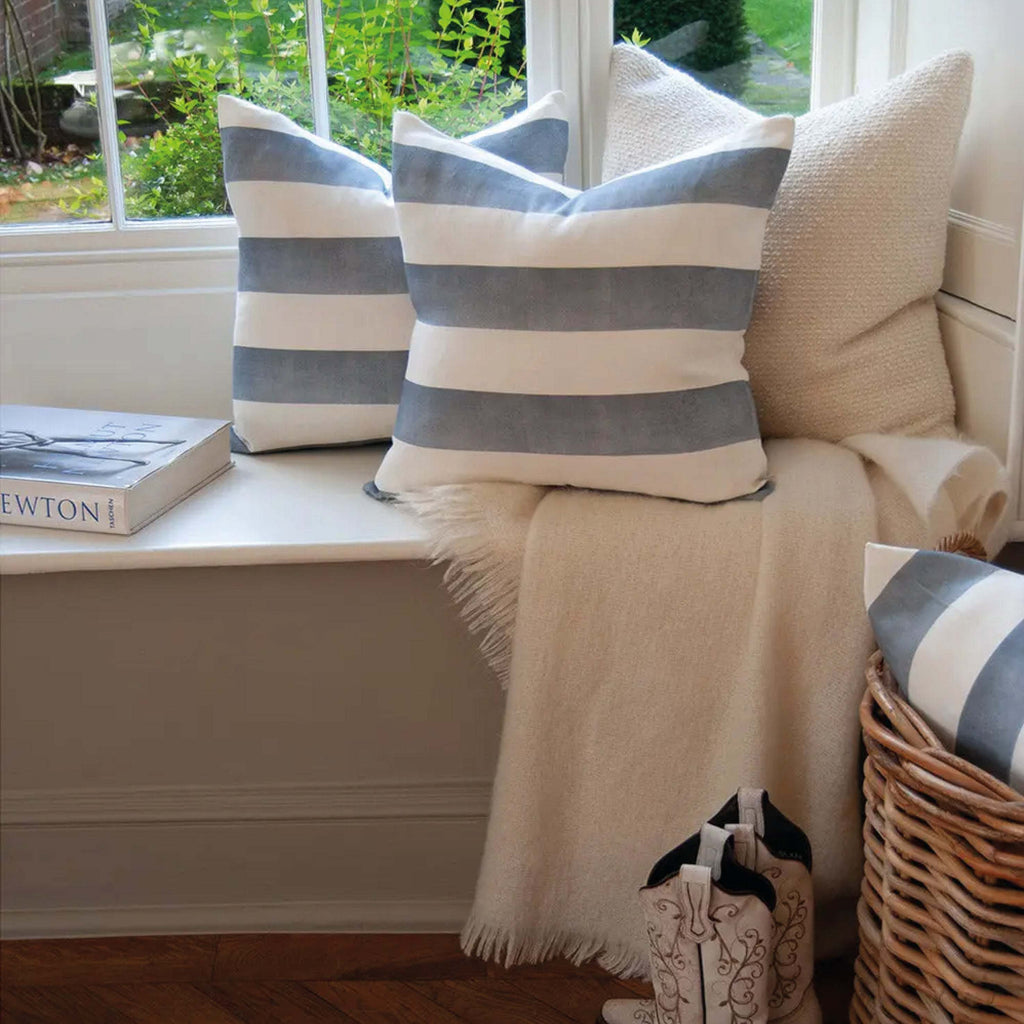 Blue Riviera Striped Linen Cushion on a window seat with white and blue stripes, blending with elegant decor.