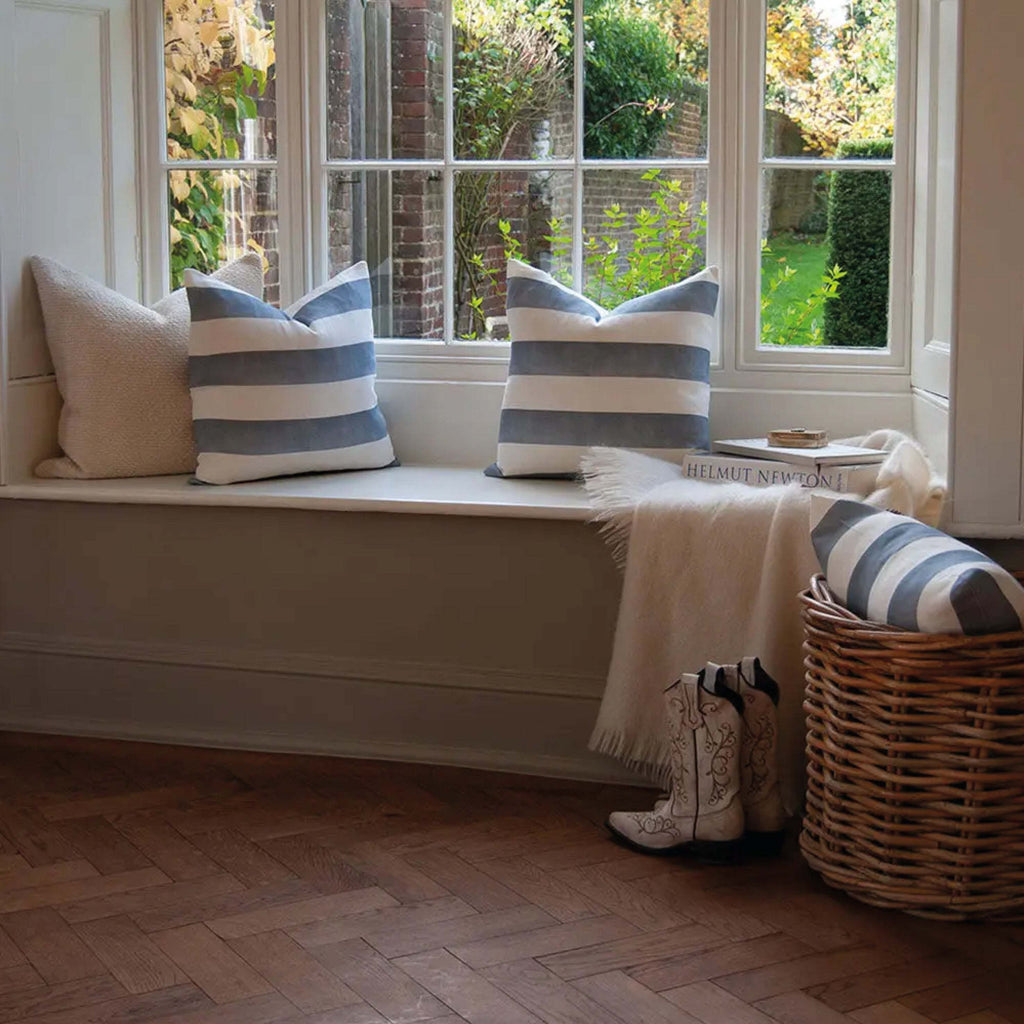 Blue Riviera Striped Linen Cushion on window seat, luxurious linen-cotton blend, timeless wide-striped design.