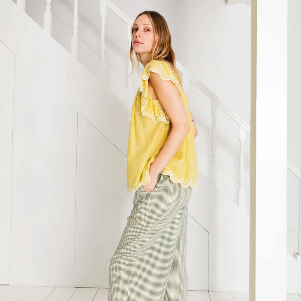 Lime yellow loose fitting hand-smock fronted top with a button back opening. Small frill neckline with white embroidered boarder on cap sleeves and hem.
Bonté Lime Marcel Top - Jo And Co Bonté Lime Marcel Top - Bonté