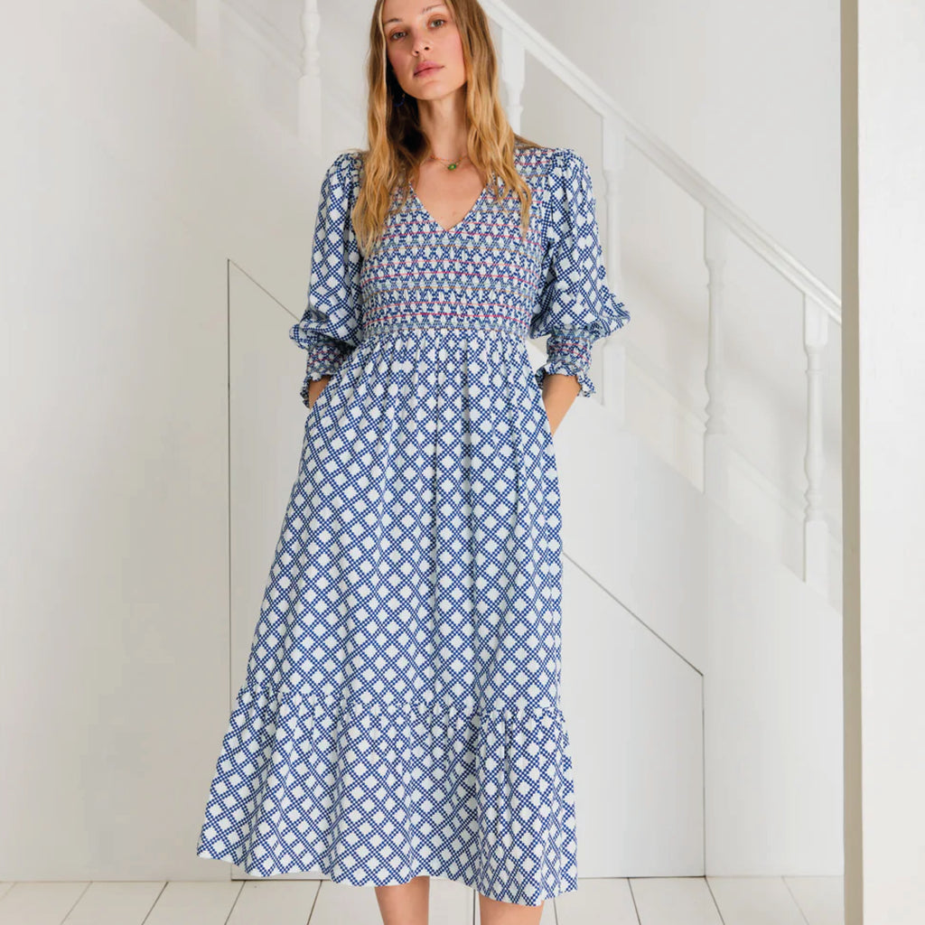 A tiered, smocked bodice dress in a geometric organic cotton poplin print with v-neck.
Bonté Blue & White Troy Dress - Jo And Co Bonté Blue & White Troy Dress - Bonté