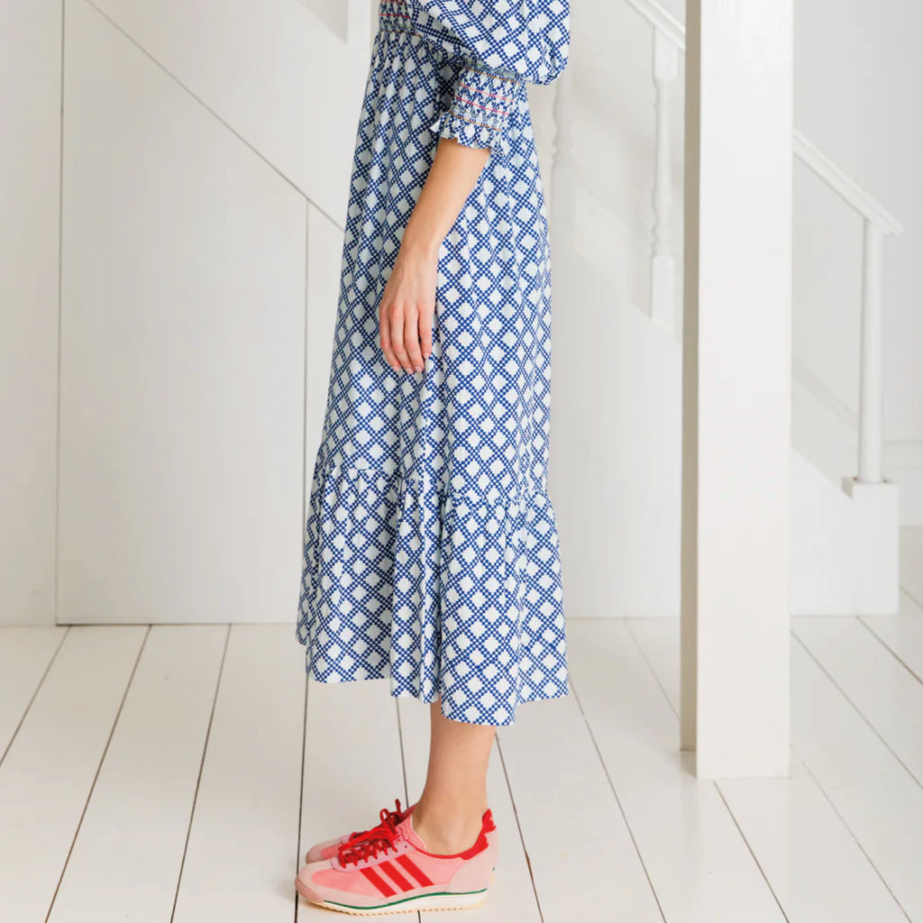 A tiered, smocked bodice dress in a geometric organic cotton poplin print with v-neck.
Bonté Blue & White Troy Dress - Jo And Co Bonté Blue & White Troy Dress - Bonté