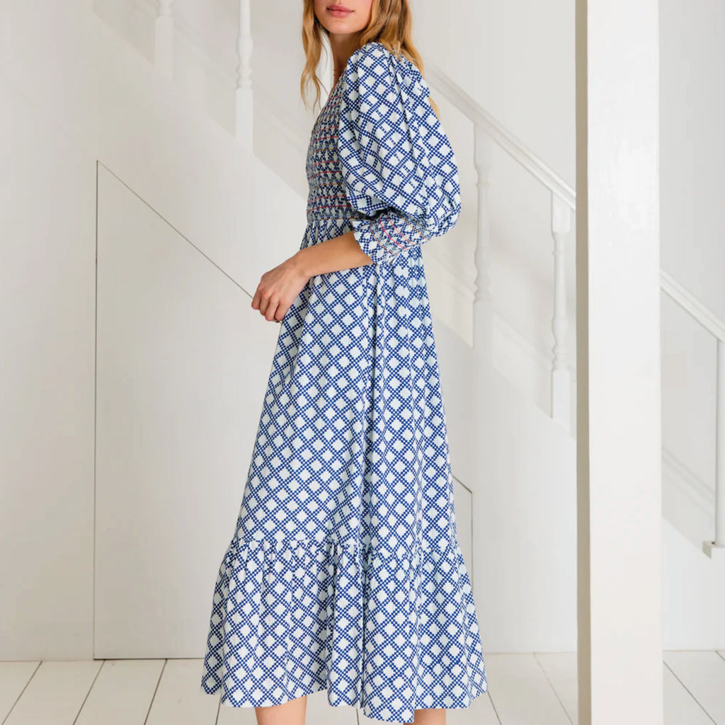 A tiered, smocked bodice dress in a geometric organic cotton poplin print with v-neck.
Bonté Blue & White Troy Dress - Jo And Co Bonté Blue & White Troy Dress - Bonté