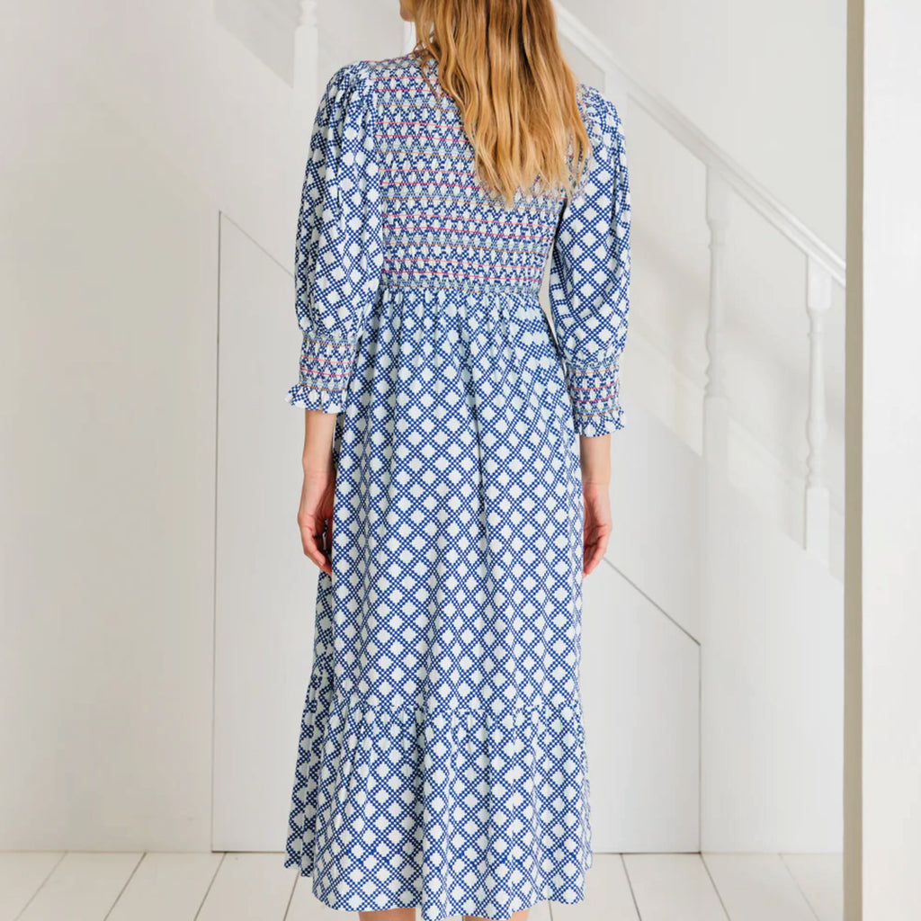 A tiered, smocked bodice dress in a geometric organic cotton poplin print with v-neck.
Bonté Blue & White Troy Dress - Jo And Co Bonté Blue & White Troy Dress - Bonté