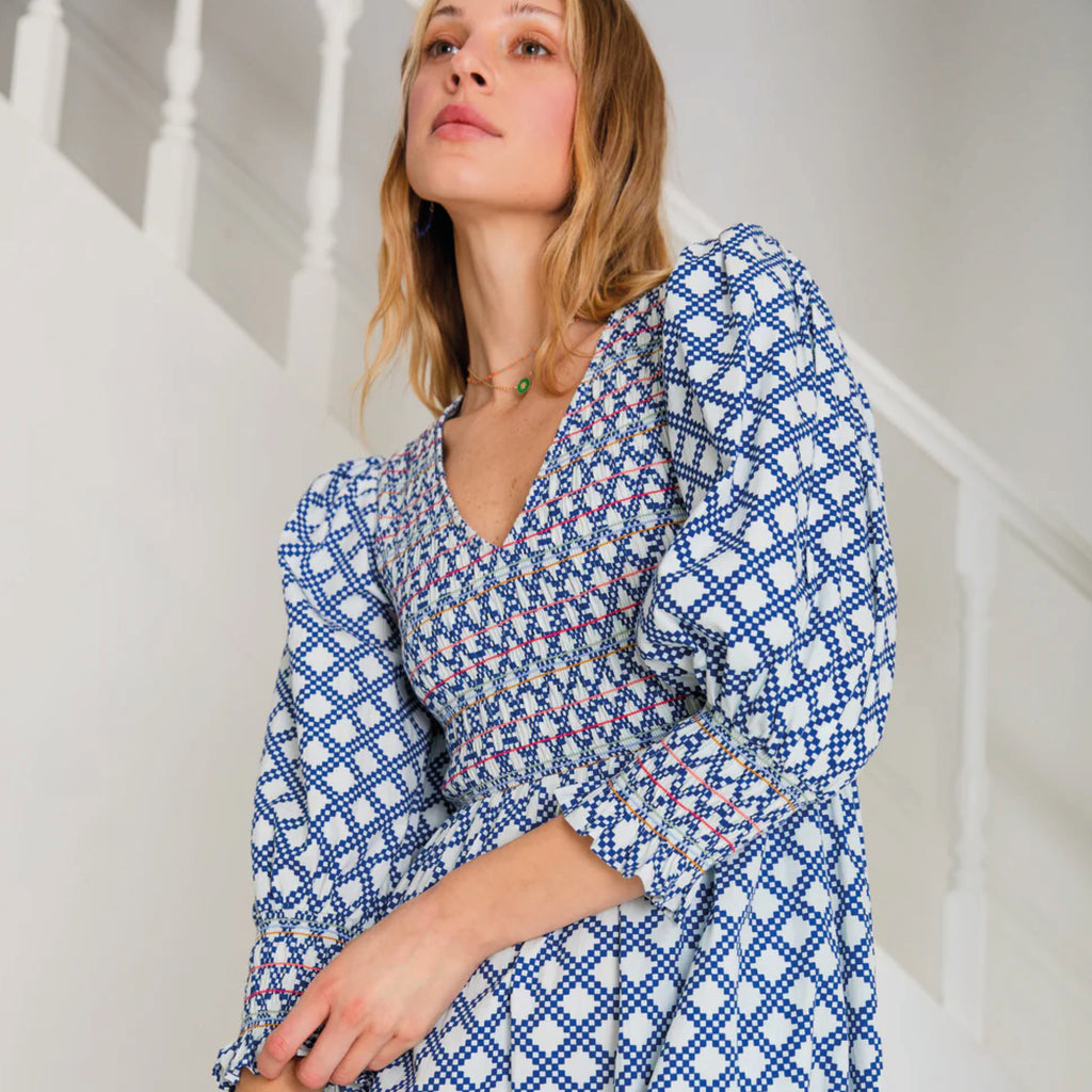 A tiered, smocked bodice dress in a geometric organic cotton poplin print with v-neck.
Bonté Blue & White Troy Dress - Jo And Co Bonté Blue & White Troy Dress - Bonté