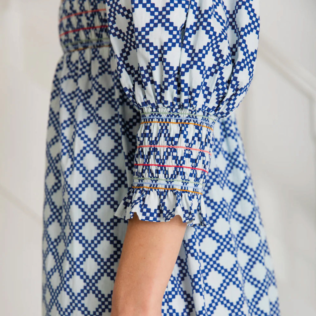 A tiered, smocked bodice dress in a geometric organic cotton poplin print with v-neck.
Bonté Blue & White Troy Dress - Jo And Co Bonté Blue & White Troy Dress - Bonté