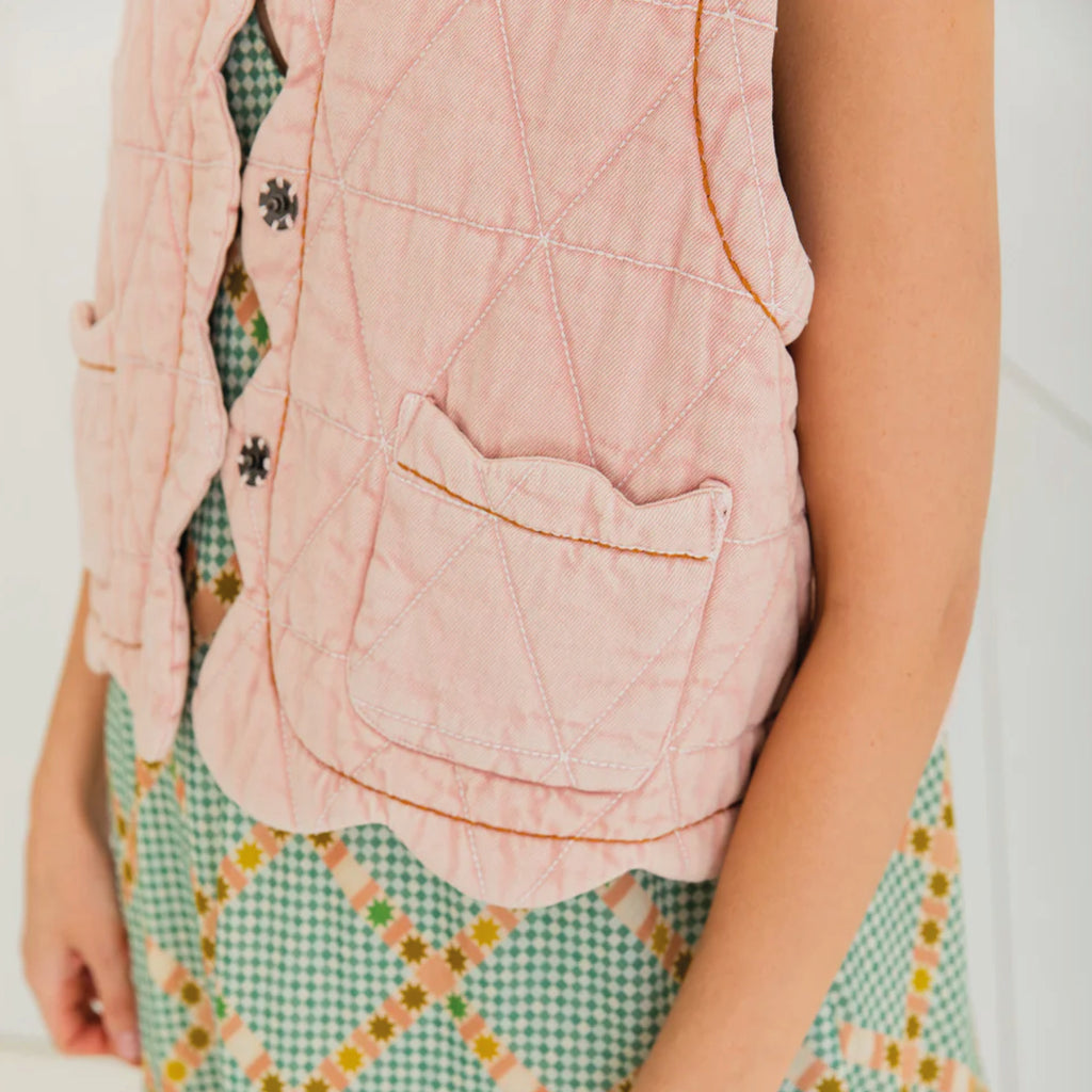 Chalk pink quilted gilet with scallop edge detail with a contrast hand running stitch detail.
Bonté Chalk Pink Estelle Gilet - Jo And Co Bonté Chalk Pink Estelle Gilet - Bonté