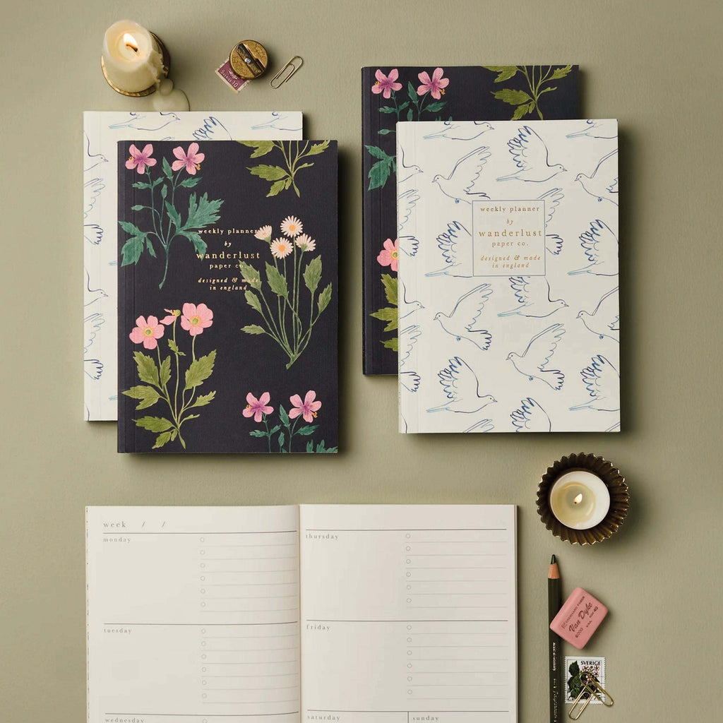 Botanical Weekly Planner with floral print by Wanderlust Paper Co, featuring monthly and weekly overviews, open layout, and England design.