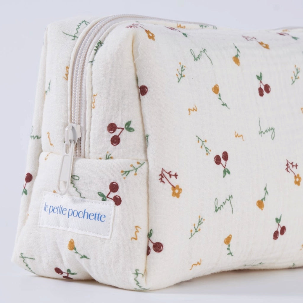 Crepe fabric wash bag with botanical pattern of hand-drawn cherries and flowers on cream cotton fabric with nylon zipper.
Cherry Wash Bag - Jo And Co Cherry Wash Bag