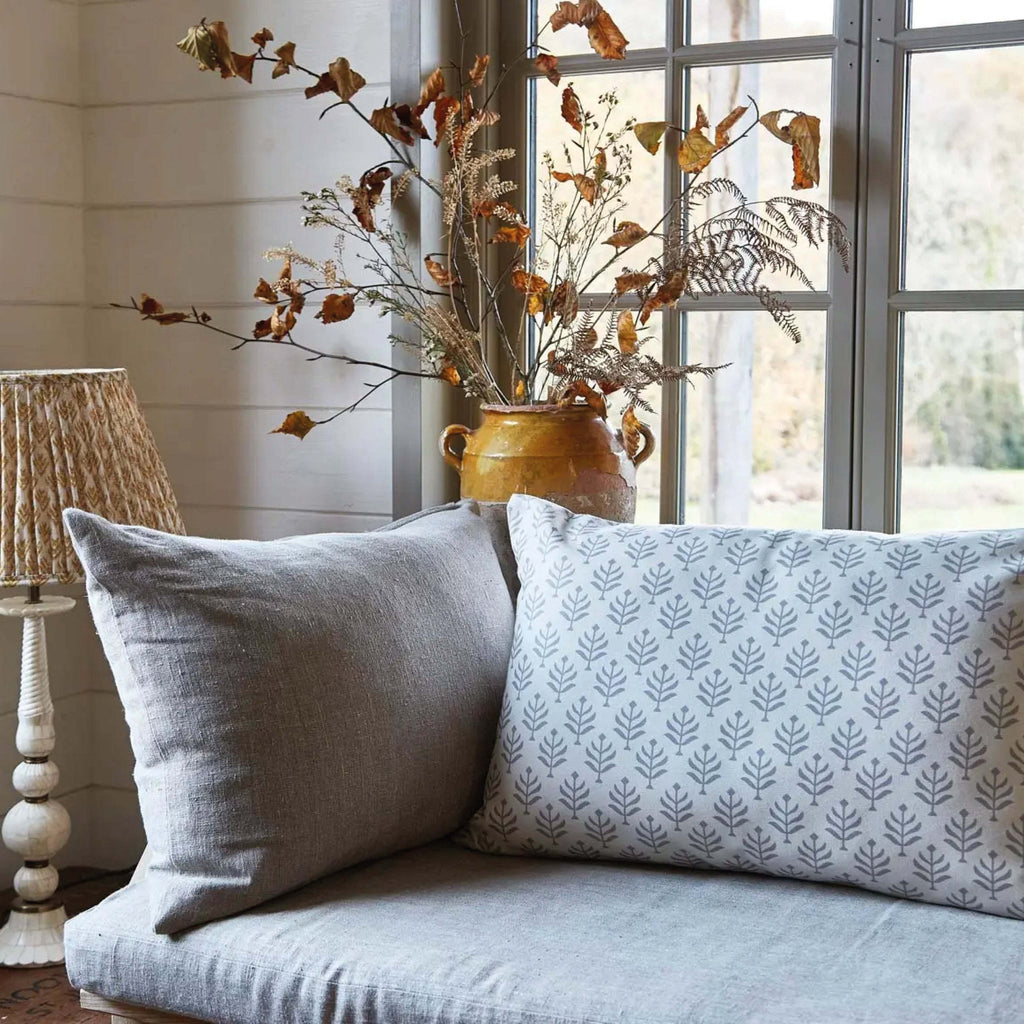 Chinchilla Fern Canvas Cushion in rectangular shape with fern print on a sofa near a window.