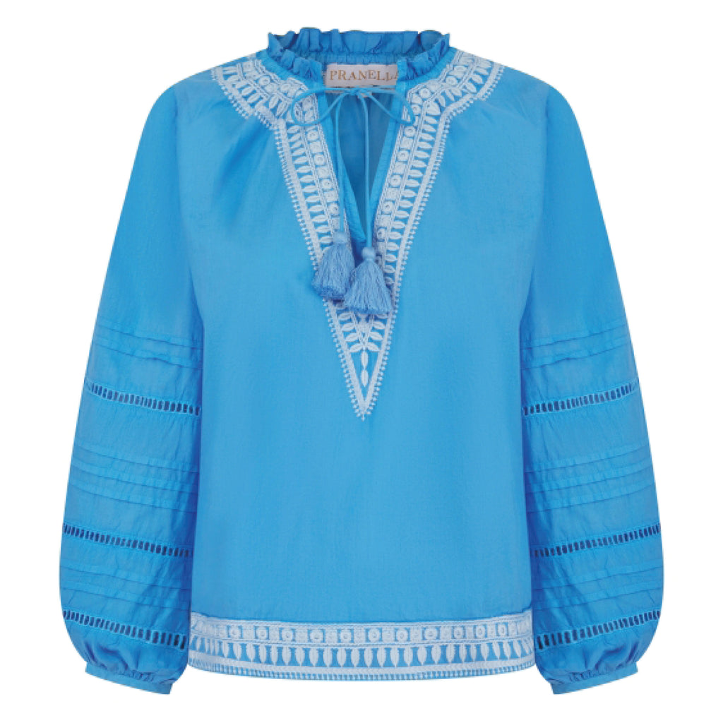 Cornflower blue blouse with embroidered neckline, hem and sleeve, balloon sleeve with ladder lace and pleating, and v-neckline.
Pranella Cornflower August Blouse - Jo And Co Pranella Cornflower August Blouse - Pranella