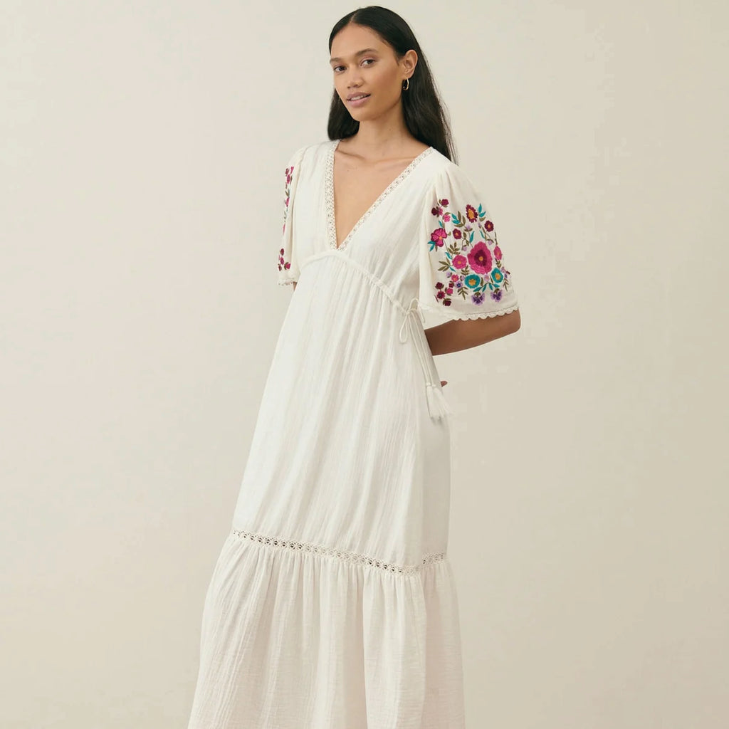 Long cream dress in organic cotton with plunging V-neck, tear drop back opening and embroidered butterfly sleeves with lace edges.
Louise Misha Cream Balina Dress - Jo And Co Louise Misha Cream Balina Dress - Louise Misha