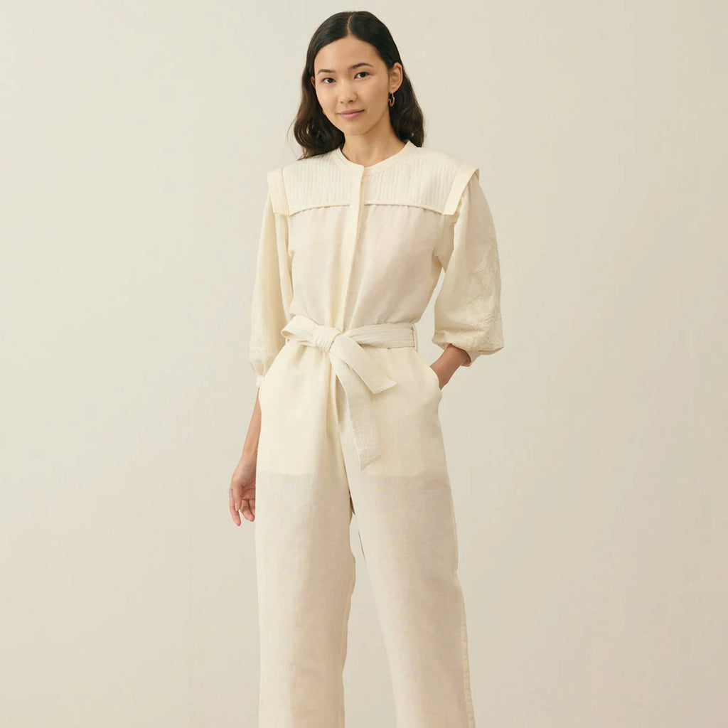 Cream cotton and linen blend jumpsuit with round neckline, lightly quilted breastplate with embroidery details. 
Louise Misha Cream Sylvianna Jumpsuit - Jo And Co Louise Misha Cream Sylvianna Jumpsuit - Louise Misha