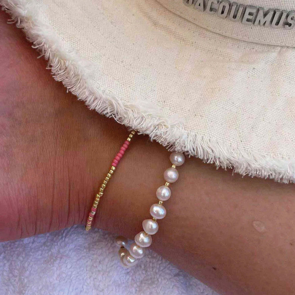 Hultquist Copenhagen Elina Anklet with coral and gold Miyuki beads on wrist.