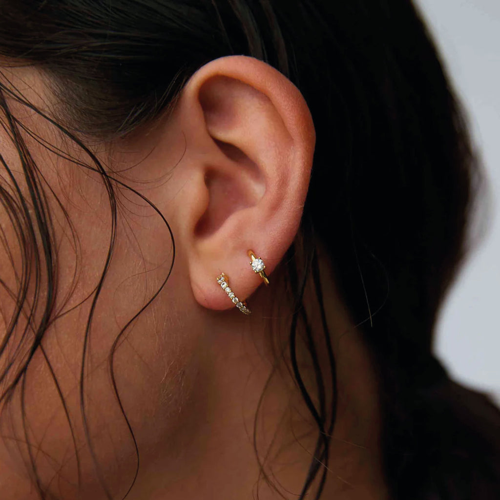 Hultquist Copenhagen Elvita Hoop Earrings in 18K gold-plated sterling silver with cubic zirconia worn on ear.