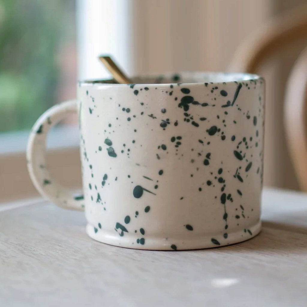 Hand finished Forest Ink Splash Mug with green ink design, matte glaze, and unique patterns.