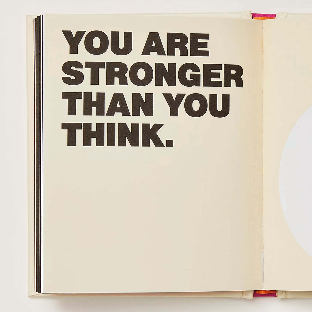 Open page of 'I Am Strong Book' with the text "You Are Stronger Than You Think" in bold lettering.