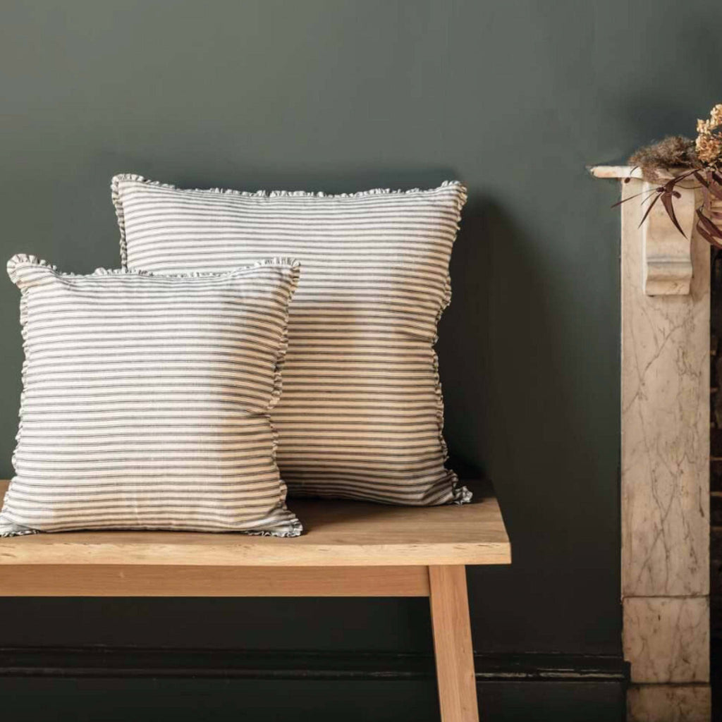 Ink Boxwell Stripe Cushion 45x45cm with linen and cotton blend, yarn dyed stripes, and frill edges, on a wooden bench.