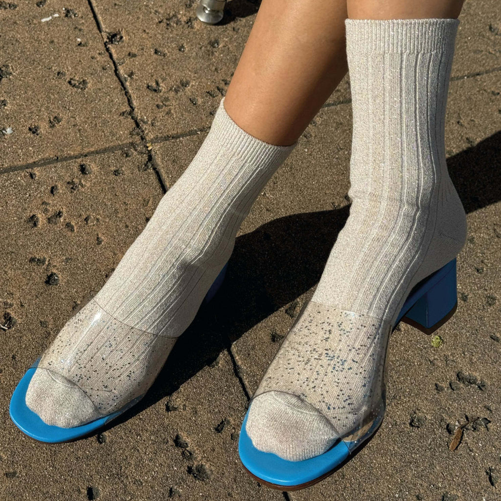 Le Bon Shoppe Ivory Gold ribbed socks with sparkle on feet.