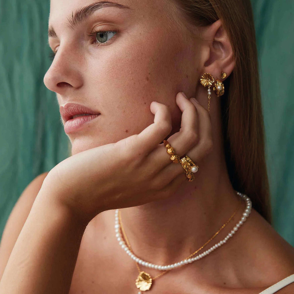 Hultquist Copenhagen Kamma Pearl Earrings on model with unique hammerhit design.