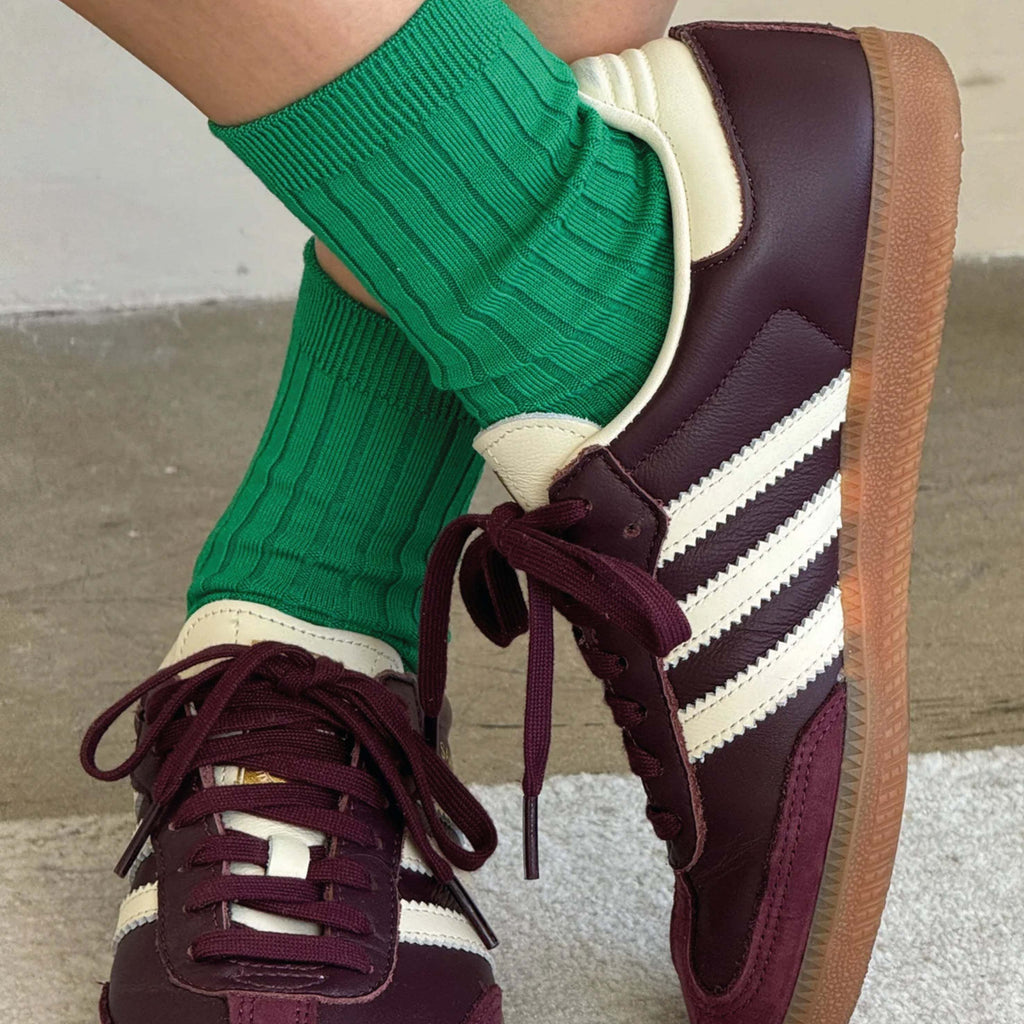 Le Bon Shoppe Kelly Green Her Socks in ribbed cotton blend, paired with burgundy sneakers.