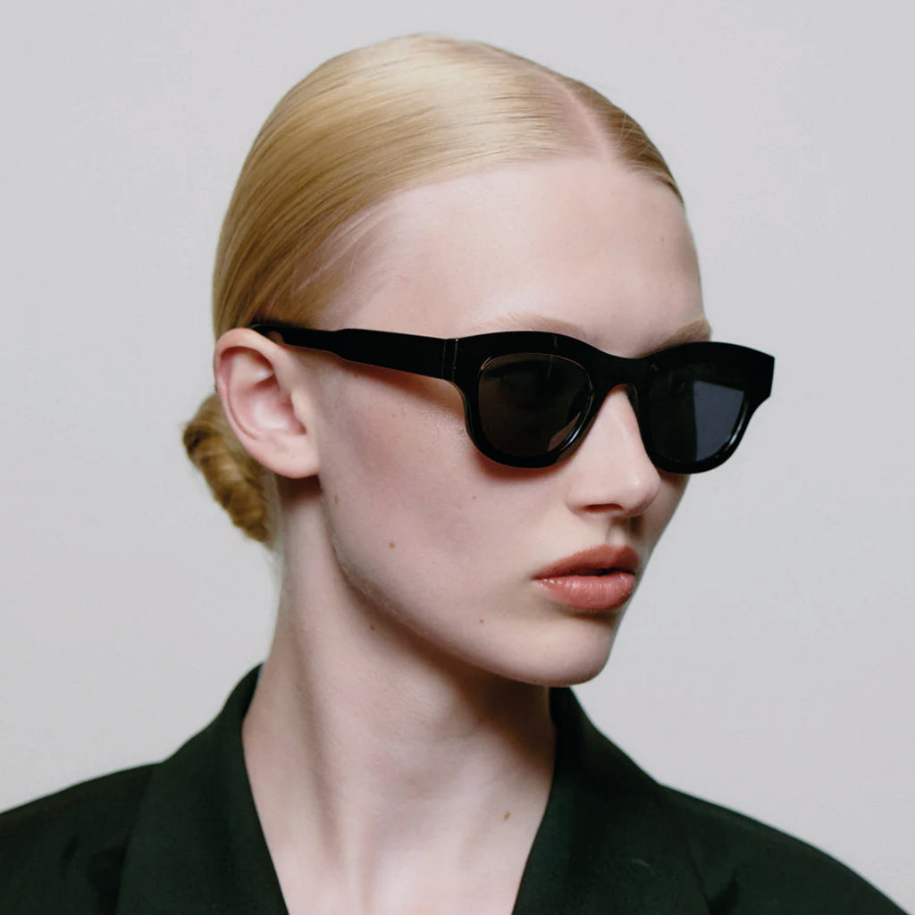 Black sunglasses with linear bottom and a rounded top.
A.KJAERBEDE Lane Black Sunglasses - Jo And Co A.KJAERBEDE Lane Black Sunglasses - A.KJAERBEDE