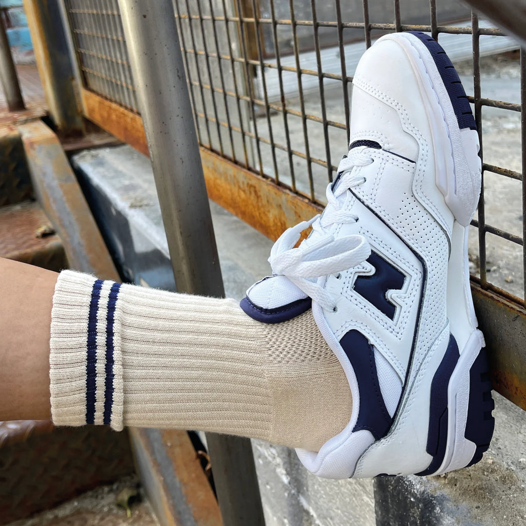 Cashew cream socks with double navy contrast stripe, crew sock length and red Le Bon Shoppe text on sole.
Le Bon Shoppe Cashew Boyfriend Socks - Jo And Co Le Bon Shoppe Cashew Boyfriend Socks - Le Bon Shoppe