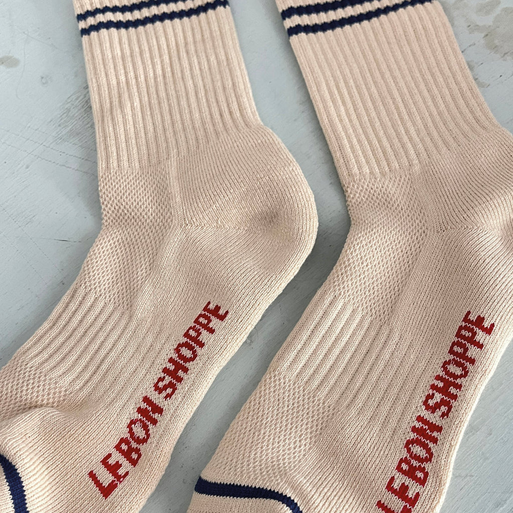 Cashew cream socks with double navy contrast stripe, crew sock length and red Le Bon Shoppe text on sole.
Le Bon Shoppe Cashew Boyfriend Socks - Jo And Co Le Bon Shoppe Cashew Boyfriend Socks - Le Bon Shoppe