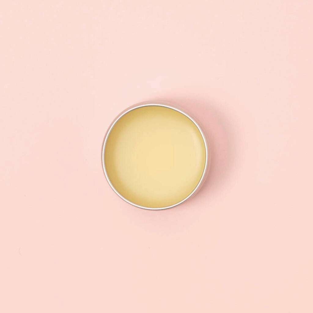 Lemon Sugar Sherbert Lemon Lip Balm 15ml in a tin on a pink background.