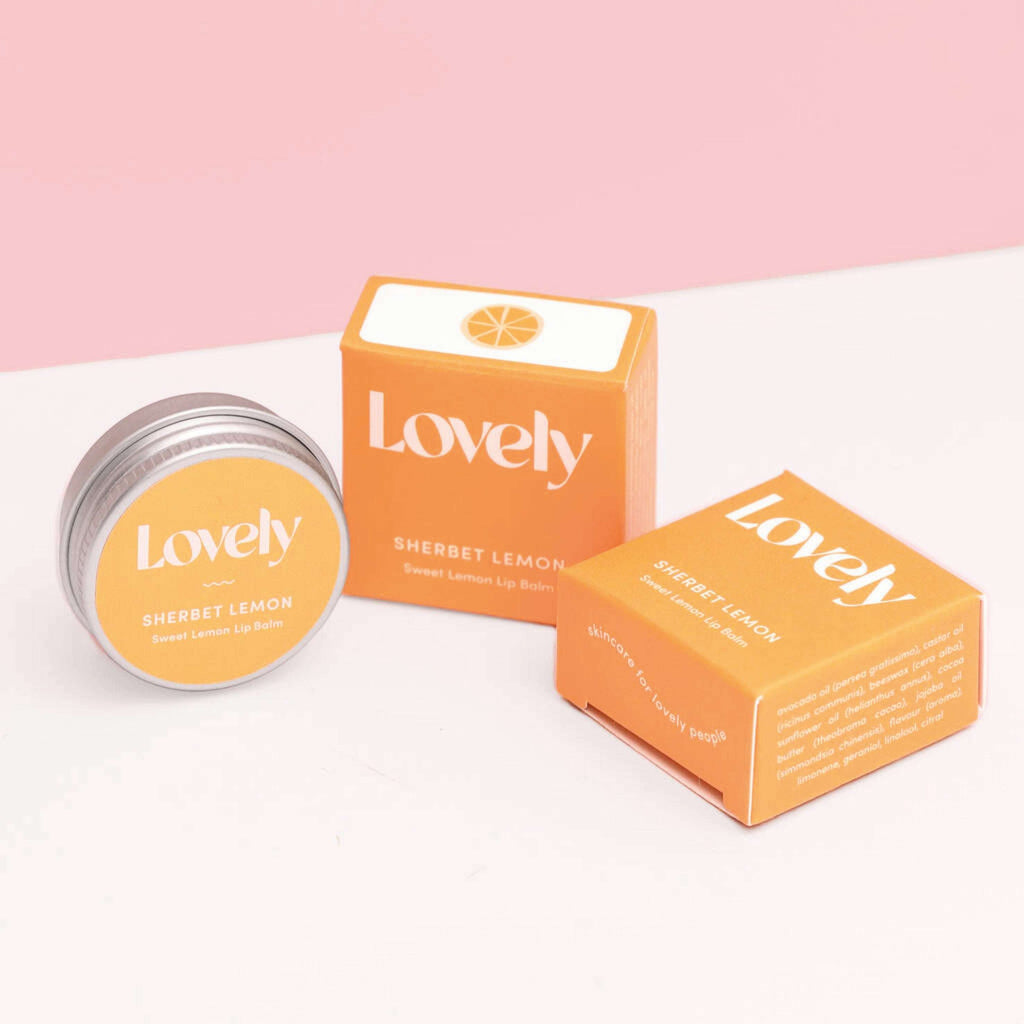 Lemon Sugar Sherbert Lemon Lip Balm 15ml in orange packaging with tin, hydrating formula.