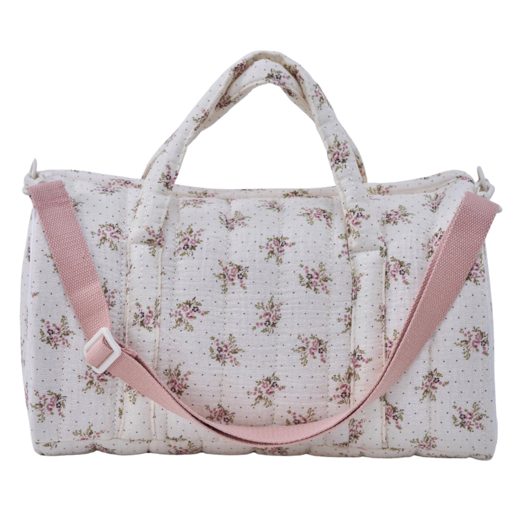 Crepe fabric duffle bag with pink roses print on cream cotton quilted fabric with handles and adjustable pink shoulder strap.
Lilac Floral Duffle Bag - Jo And Co Lilac Floral Duffle Bag