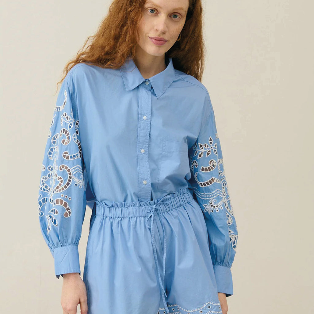 Blue cotton shirt with puff sleeves with large embroideries, handmade openwork details and shirt cuffs.
Louise Misha Blue Reynald Shirt - Jo And Co Louise Misha Blue Reynald Shirt - Louise Misha