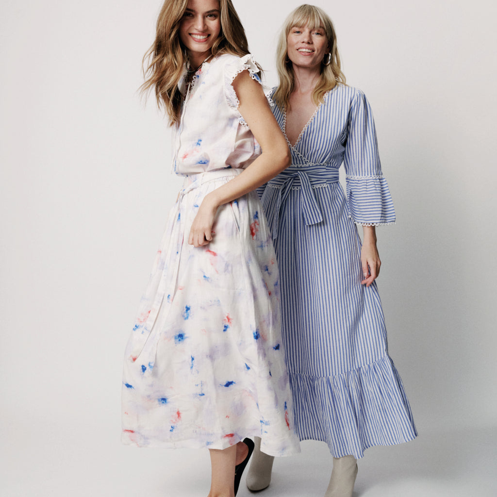 Long blue striped feminine dress with a ruffle detailed crossover v-neck and elastic waist with a flowy pleated panel at bottom.
Moliin Copenhagen Turkish Sea Dulce Dress - Jo And Co Moliin Copenhagen Turkish Sea Dulce Dress - Moliin Copenhagen