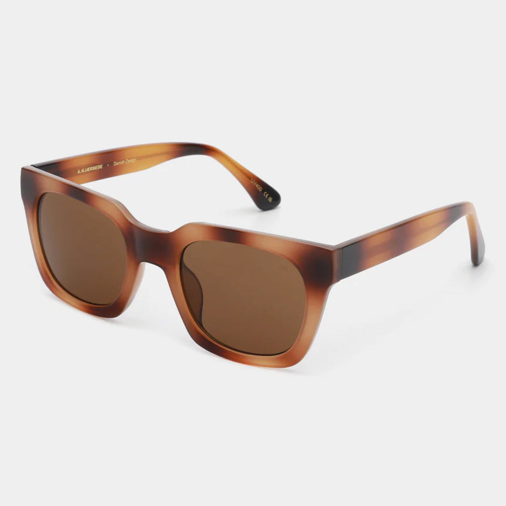 Brown square shape and medium-sized frame sunglasses.
A.KJAERBEDE Nancy Demi Brown Sunglasses - Jo And Co A.KJAERBEDE Nancy Demi Brown Sunglasses - A.KJAERBEDE