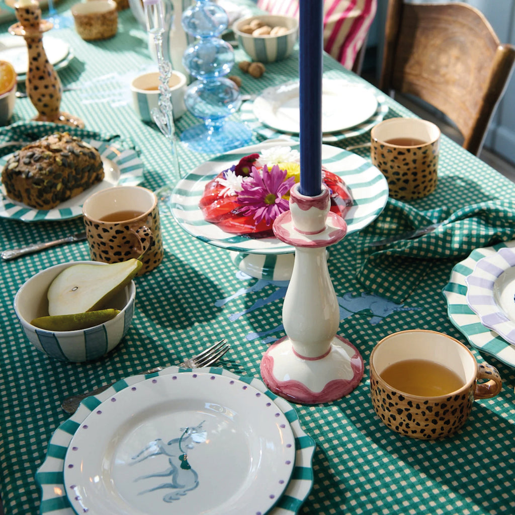 Pink Radiant Candle Holder with soft pink details and ivory-white design on a green checkered table.