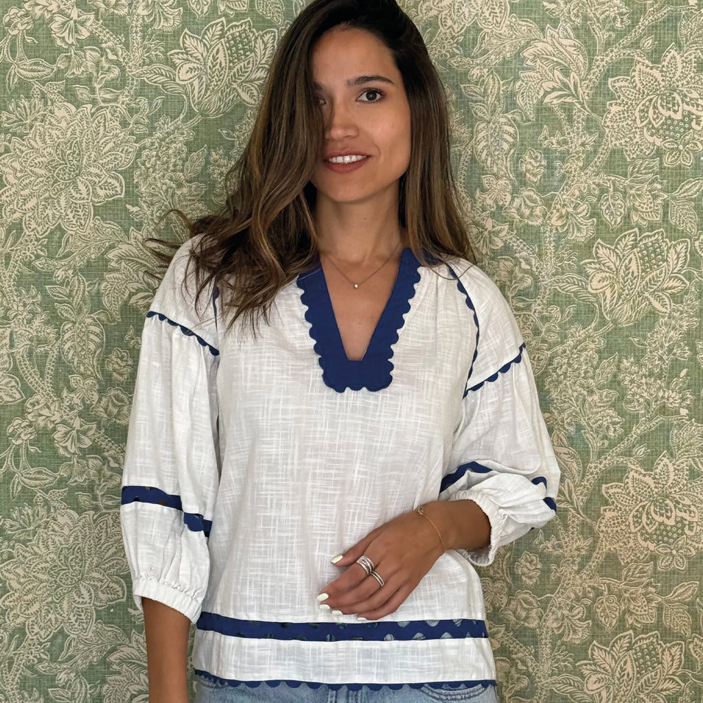 Blouse in white cotton with peek-a-boo giant ric rac decoration and rectangular keyhole neckline in navy with elasticated three-quarter length balloon sleeves.
Rose And Rose White & French Blue Farringdon Blouse - Jo And Co Rose And Rose White & French Blue Farringdon Blouse - Rose And Rose