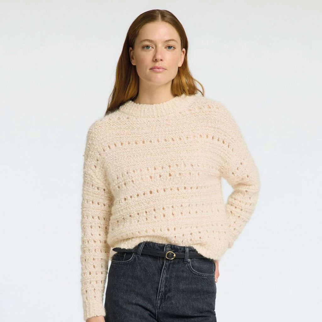 Selected Femme Birch Alfi Crochet Knit sweater with round neck and long sleeves, shown on a model wearing denim skirt.