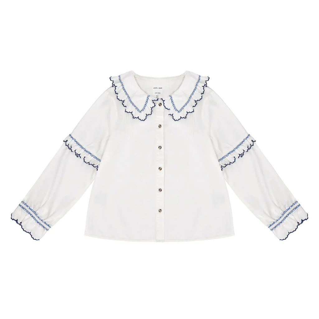 White cotton blouse with blue embroidered frill collar and sleeves.
Seventy + Mochi Ecru & Electric Blue Phoebe Blouse - Jo And Co Seventy + Mochi Ecru & Electric Blue Phoebe Blouse - Seventy + Mochi