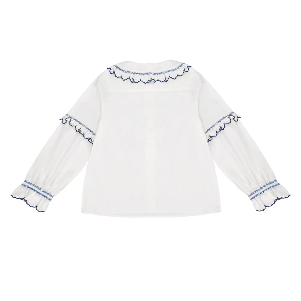 White cotton blouse with blue embroidered frill collar and sleeves.
Seventy + Mochi Ecru & Electric Blue Phoebe Blouse - Jo And Co Seventy + Mochi Ecru & Electric Blue Phoebe Blouse - Seventy + Mochi