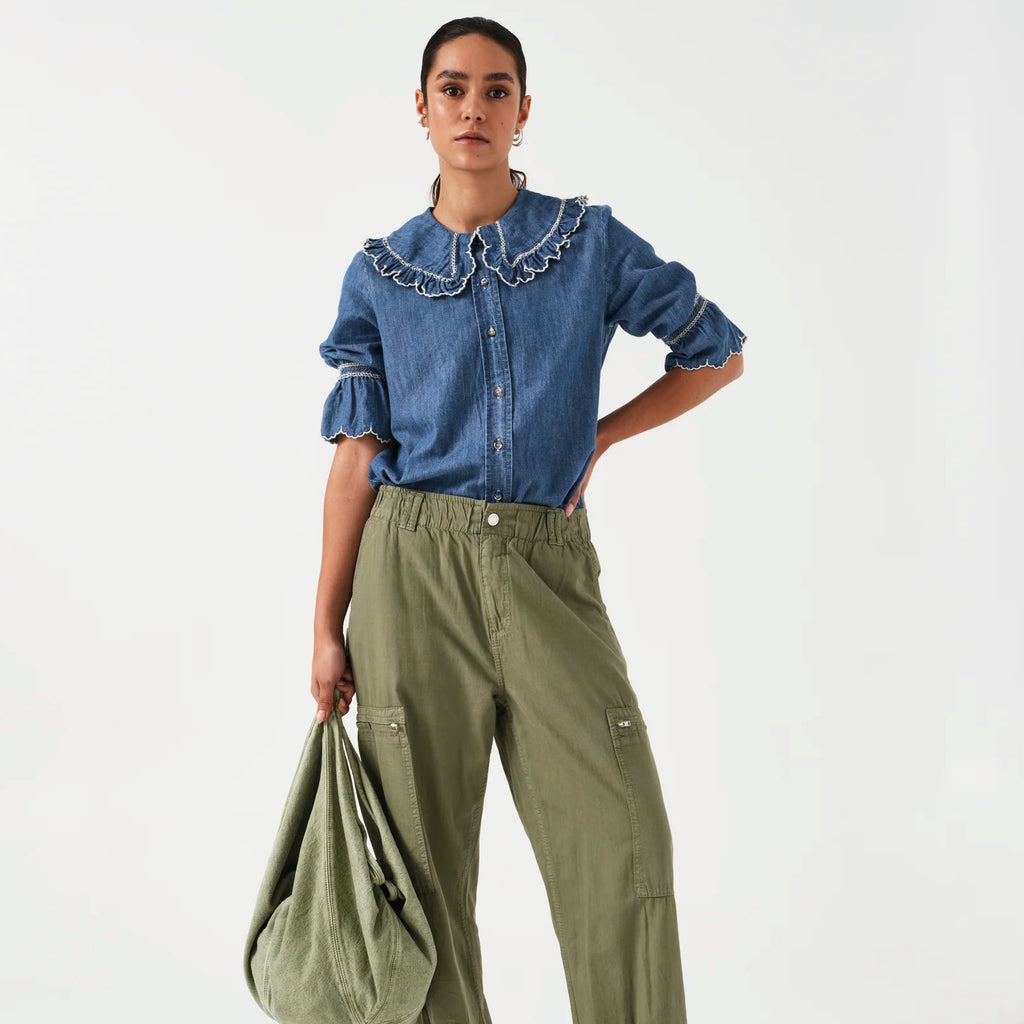 Indigo denim blue blouse with embroidered frill collar and cuffs and feminine cropped sleeves.
Seventy + Mochi Indigo Denim Daisy Blouse - Jo And Co Seventy + Mochi Indigo Denim Daisy Blouse - Seventy + Mochi