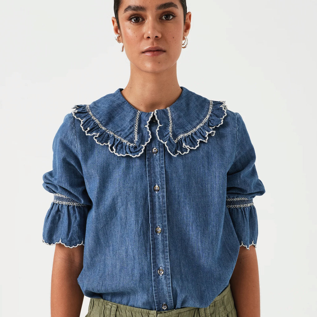 Indigo denim blue blouse with embroidered frill collar and cuffs and feminine cropped sleeves.
Seventy + Mochi Indigo Denim Daisy Blouse - Jo And Co Seventy + Mochi Indigo Denim Daisy Blouse - Seventy + Mochi