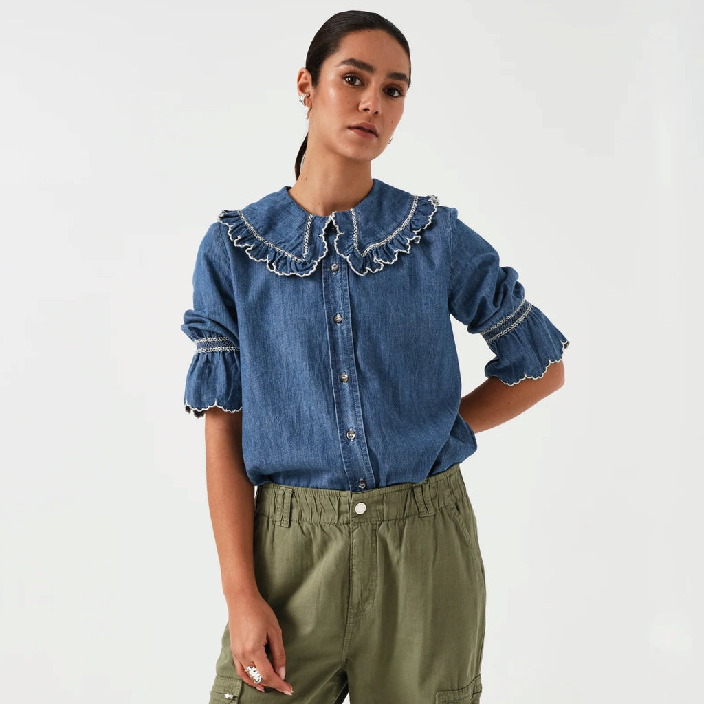 Indigo denim blue blouse with embroidered frill collar and cuffs and feminine cropped sleeves.
Seventy + Mochi Indigo Denim Daisy Blouse - Jo And Co Seventy + Mochi Indigo Denim Daisy Blouse - Seventy + Mochi