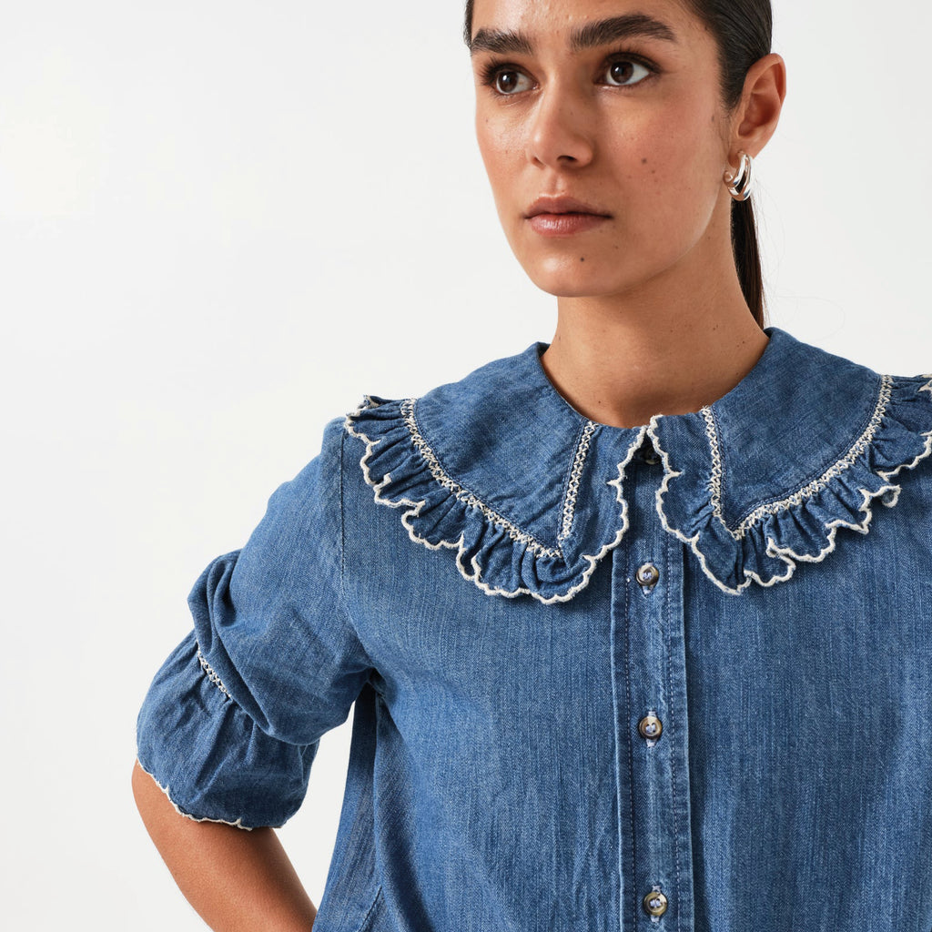 Indigo denim blue blouse with embroidered frill collar and cuffs and feminine cropped sleeves.
Seventy + Mochi Indigo Denim Daisy Blouse - Jo And Co Seventy + Mochi Indigo Denim Daisy Blouse - Seventy + Mochi