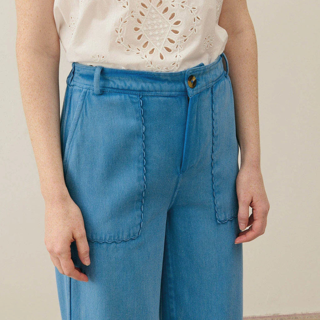 Straight cut blue cotton trousers with front patch pockets with slant opening and rickrack edges.
Louise Misha Stone Blue Florette Trousers - Jo And Co Louise Misha Stone Blue Florette Trousers - Louise Misha