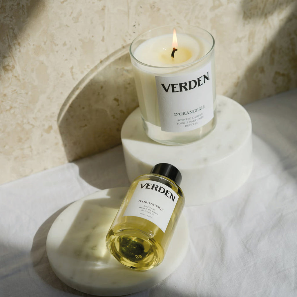 Verden D'orangerie scented candle with citrus and orange blossom aroma, placed on a marble stand.